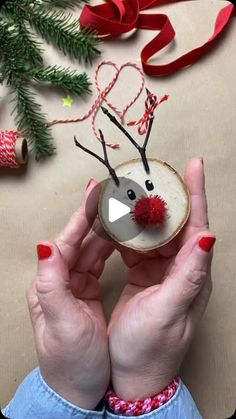 someone is making a reindeer ornament out of coconut