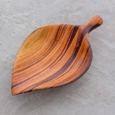 a wooden bowl sitting on top of cement