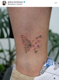 a small butterfly tattoo on the ankle