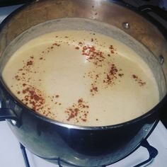 a pot filled with liquid sitting on top of a stove