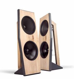 two wooden speakers sitting side by side on top of each other, one is black and the other is white