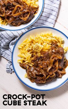 two white plates topped with pasta and beef