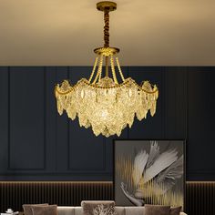 a fancy chandelier hangs from the ceiling above a couch in a living room