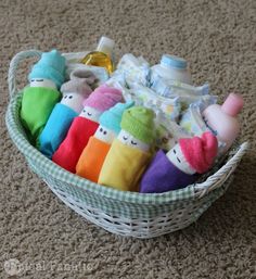 a basket filled with lots of different colored stuffed animals and bottles on the floor next to each other