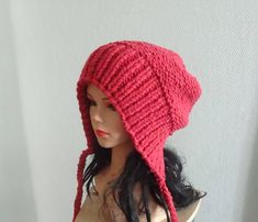 a female mannequin wearing a red knitted hat