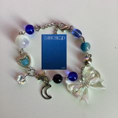 a bracelet with charms and a book on it