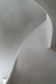 the interior of a white building with curved walls