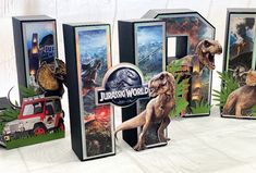 three cardboard boxes with dinosaurs on them