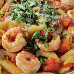 pasta with shrimp, tomato sauce and parmesan cheese on the top is ready to be eaten