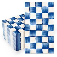 a stack of blue and white napkins sitting next to each other on top of a table