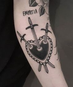 a tattoo with two swords on it and the words emptia in black ink