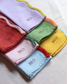 six personalized towels laid out on top of each other with the names and colors