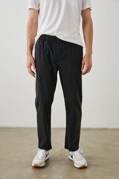 Half way between relaxed and slim fit to allow you to stay comfortable for easy movement yet still look refined. Roll and cuff for a cool and casual styled look. Made from a soft lightweight cotton trouser this pant features an elastic waist and welt back pockets. Garment dyed for a worn, vintage look. 52% Cotton | 46% Modal | 2% Spandex. Casual Pants With Elastic Cuffs And Straight Hem, Casual Straight Leg Pants With Elastic Cuffs, Straight Leg Bottoms With Ribbed Waistband, Everyday Straight Leg Bottoms With Ribbed Waistband, Relaxed Fit Cropped Leg Casual Chinos, Casual Relaxed Fit Cropped Leg Chinos, Relaxed Fit Tapered Leg Everyday Chinos, Relaxed Fit Tapered Leg Pants With Elastic Cuffs, Versatile Straight Leg Relaxed Fit Chinos