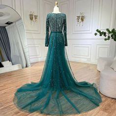 Exquisite mermaid silhouette gown with an elegant green overskirt, perfect for weddings and formal events. Crafted with meticulous attention to detail and high-quality materials for a luxurious feel. Features intricate beadwork that adds a touch of opulence and glamour. Inspired by Dubai luxury fashion, designed to exude elegance and sophistication. Ideal attire for Muslim women attending weddings, parties, or formal events. Flattering fit that accentuates curves while providing comfort and ease Dubai Gowns, Beaded Mermaid, Long Evening Dresses, Dubai Luxury, Mermaid Evening Dresses, Mermaid Silhouette, Evening Dresses Long, Formal Evening Dresses, Muslim Women