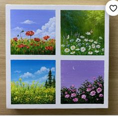 four paintings of flowers in different colors and sizes on a wooden surface with a white heart above them