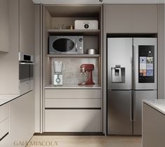 a modern kitchen with stainless steel appliances and white counter tops, along with beige cabinets