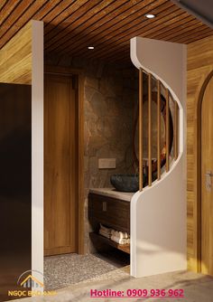 a spiral staircase leading to a bathroom with stone walls and wood ceilinging in a home