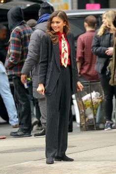 a woman in a suit and tie on the street