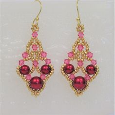 pink and gold earrings with beads on them