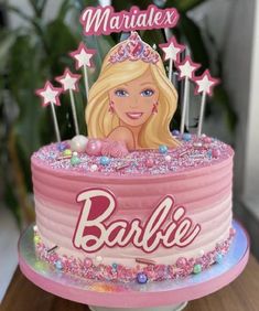 a barbie birthday cake with pink frosting and stars