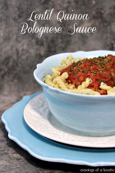 a bowl filled with pasta on top of a blue plate