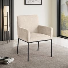 a white chair sitting in front of a window