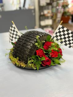 a hat decorated with flowers on top of a table