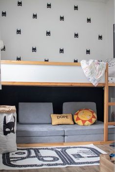 there is a bunk bed in the children's room with black cats on the wall