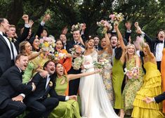 a group of people that are posing for a picture with their arms in the air