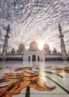 the sun is setting over an elaborately designed mosque in abura, abura