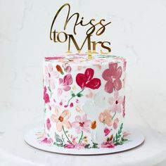 a cake decorated with flowers and the words miss to mrs