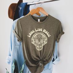 "This Long Live Music Shirt is a great gift for music teacher, gift for musician, or gift for music lover.    This soft boho Mexican skull with a headphone music shirt comes in 7 soft and comfort color options, white, heather mauve, natural, black, heather olive, yellow, and heather Columbia blue. Size recommendation: Please refer to the measurement on the size chart carefully.  We feel that the shirts fit true size.  If you want the shirt to snug on your body for a fitted look, you may order th Headphone Music, Music Teacher Gift, Gift For Musician, Mexican Skull, Camping Shirts, Music Teacher Gifts, Musician Gifts, Columbia Blue, Gift For Music Lover