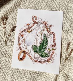 a card with an image of a ring and flowers on it