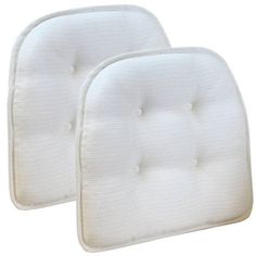 two white pillows sitting next to each other