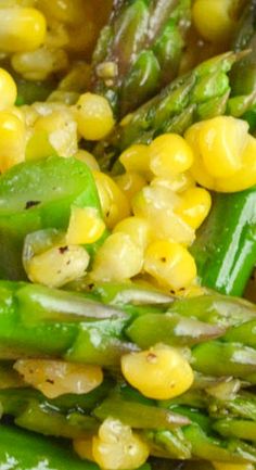 asparagus, corn and green beans are mixed together in a dish that is ready to be eaten