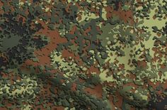 an image of camouflage fabric that looks like it could be used for clothing or other items