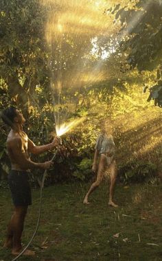 two men are spraying water on each other