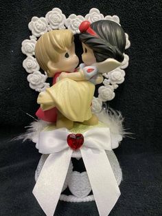 a figurine of two children kissing on top of each other