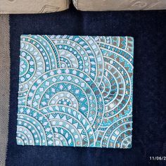 a blue and white area rug sitting on top of a floor next to a couch