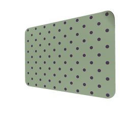 an image of a green and black polka dot pattern wall hanging on a white wall