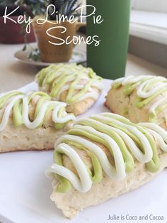 a white plate topped with slices of pastry covered in frosting and green icing