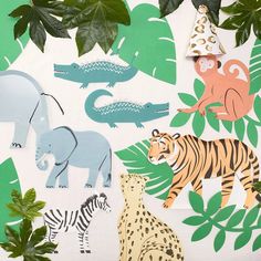 jungle animals and giraffes are featured on the wall with green leaves in the background