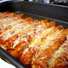 a pan filled with cheesy pizza on top of a stove