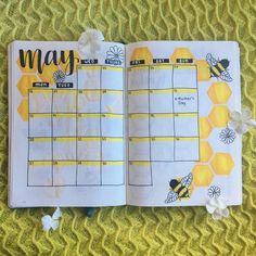 an open planner with bees and flowers on it