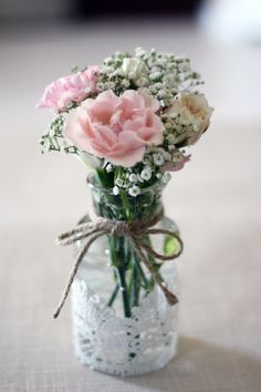 a vase filled with flowers sitting on top of a table