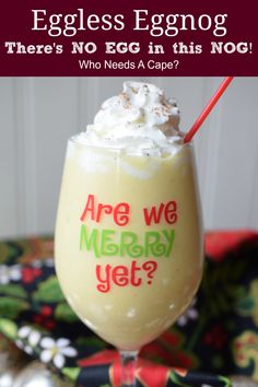 an eggless eggnog drink with whipped cream on top and the text are we merry yet?