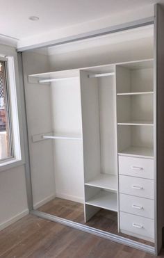 an empty white closet with shelves and drawers