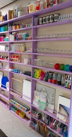 a purple shelf filled with lots of craft supplies