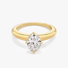 a yellow gold engagement ring with an oval cut diamond