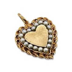 This super cute and chunky gold & pearl heart charm is crafted in 14K Yellow gold. Measures without bail: H:26.5x W:24.35 D:3.80mm With bail: H 32.2mm Metal:14K Yellow Gold Pearls: 18 seed pearls 2.4-2.6mm each. Weight: 6.34 grams Circa 1960s Every Antique piece of jewelry we sell at Heirloom Pavé has been checked for safety of each prong and repaired as needed. ***With any pre-owned/Vintage/Antique items, it is common to have some wear, As we inspect each piece of our jewelry, we make sure the Heart-shaped Yellow Gold Jewelry With Pearl Charm, Yellow Gold Heart Jewelry With Pearl Charm, Elegant Heart Pendant Charm With Beads, Pearl Heart, Seed Pearl, Gold Pearl, Antique Items, Heart Charm, Charm Necklace